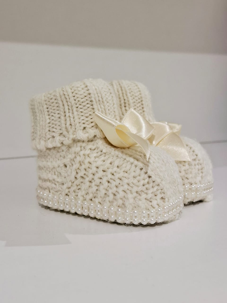 Knitted wool ribbon and pearl adorned boots