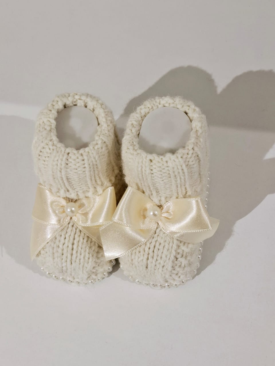 Knitted wool ribbon and pearl adorned boots