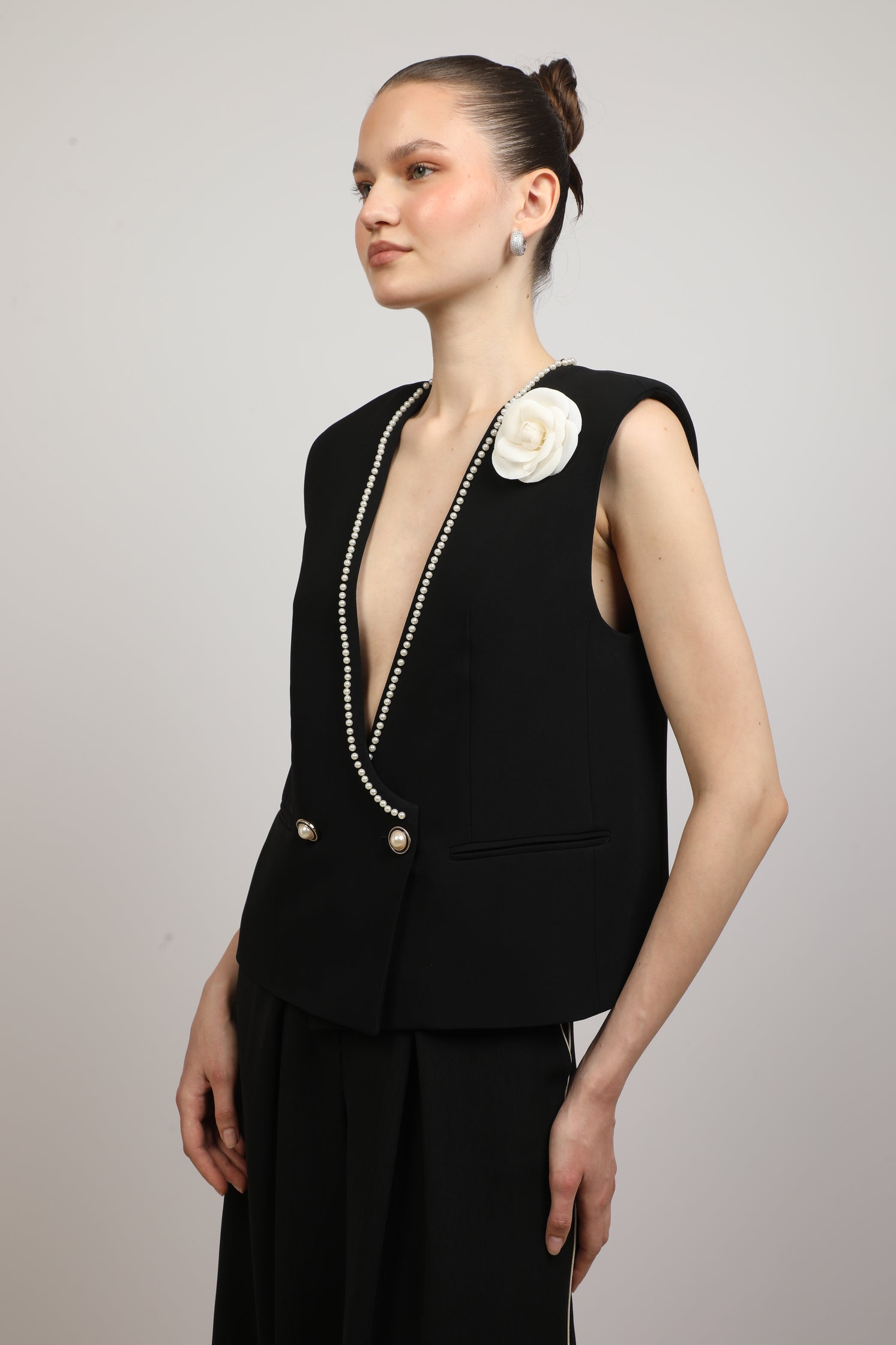 Black Vest with a flower brooch