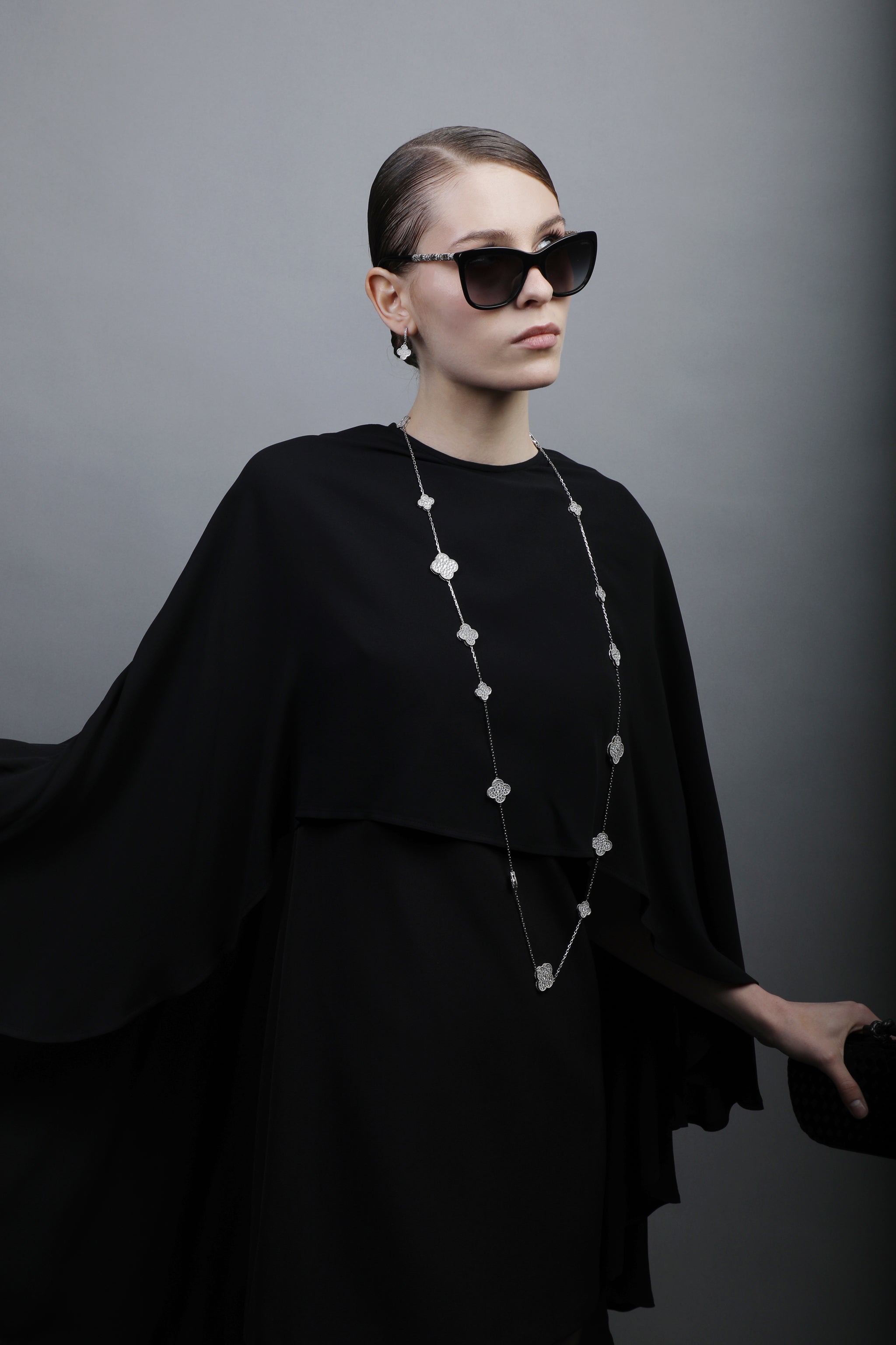 Elegant All-Black Ensemble with Cape Detailing